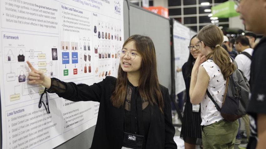 PhD student explaining a poster