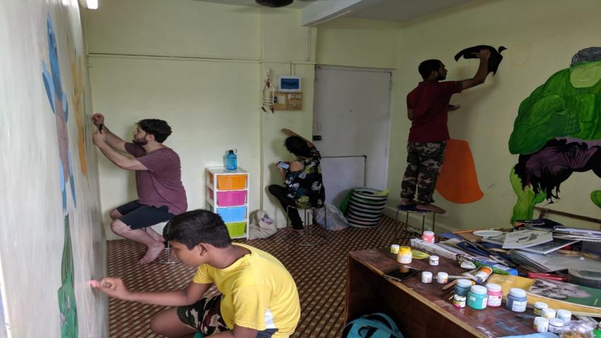 Makers paint walls at MakerGhat in India.